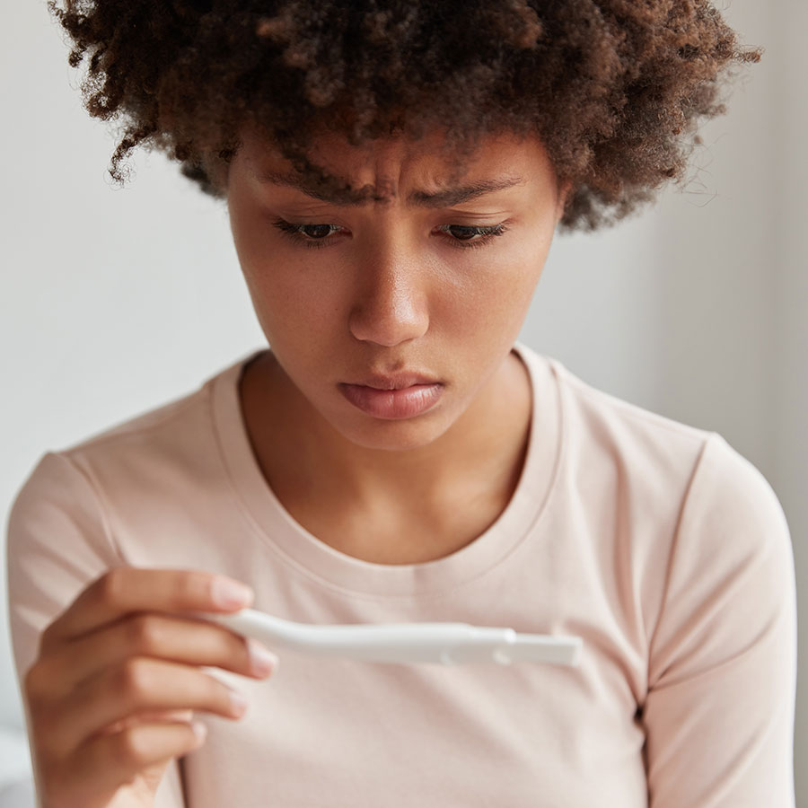 image of young woman reading negative pregnancy test