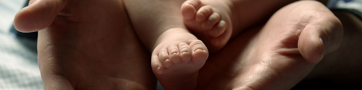 image of baby feet being held by parent